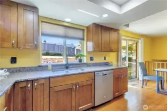 Well appointed kitchen with stainless steel appliances and a back yard view.