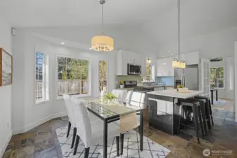 Sliding glass doors off the dining nook open directly to the composite deck, creating effortless indoor-outdoor flow. This layout makes entertaining easy and extends the living space into the beautifully designed outdoor areas.