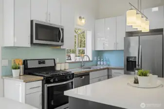 The thoughtfully arranged kitchen offers an efficient work triangle, ample counter space and excellent storage. The center island serves as the heart of the room—perfect for meal prep, serving, homework sessions or gathering with guests.