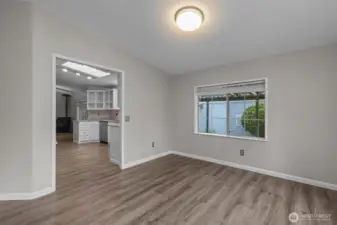 Large Kitchen stays bright with skylights and freshly painted cabinetry.