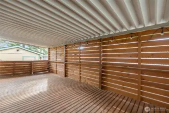 From the Covered Deck looking toward the Carport that comfortably parks 3 cars!