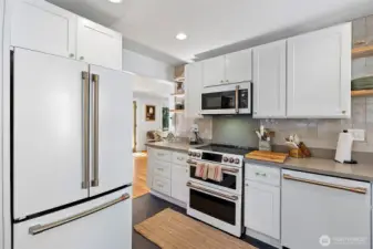 High-end GE Cafe' appliances have been chosen specifically to elevate this amazing kitchen space.