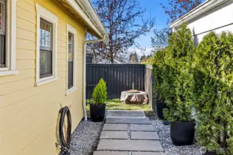 More of the side yard leading to stairs to access the crawlspace.
