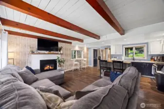 The living room is open to the kitchen and dining area and the wood ceilings with large cedar beams give the home a warm, cottage-type feeling. The gas fireplace is wonderful on those chilly winter days and evenings.