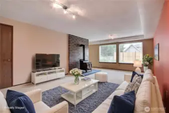Downstairs living room has great light and a woodburning stove.. This home has so much space!