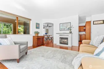 The living room is just off the kitchen and dining area, and has a cozy electric fireplace