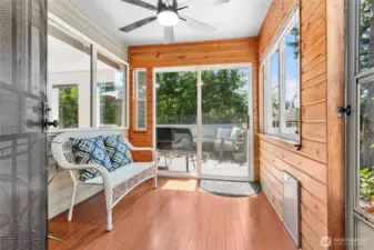 The sunroom is a perfect spot for morning coffee, with a great view of the private backyard! It has a sliding door to the deck and a separate entrance with steps down to the backyard.