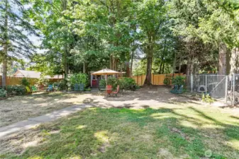 The backyard is fully fenced with 2 gates, one on each side of the house, and a dog run/kennel. A large section of the back fence panel in new!