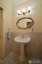 The common bath is conveniently located near bedroom #2 and 3. The floors are tiled and heated for your comfort and ovely tiles extend half way up the wall. A pedestal sink, crown moldings and a large built in storage cabinet (or the right side) are nice features.