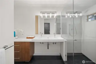 3/4 bathroom with dual sinks in the primary bedroom
