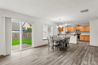 Looking from the family/great room toward the dining area an open kitchen.