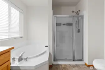 The prijmary bathroom with dual vanity sink, soaking tub and step in shower.