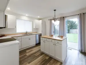 So much natural light!  Beautiful, private backyard.   Back of property borders road, but sits high above it, so foot traffic & cars have no view into yard.  Mature plantings.