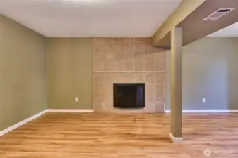 Downstairs Family Room with Tile Surround Wood Fireplace.