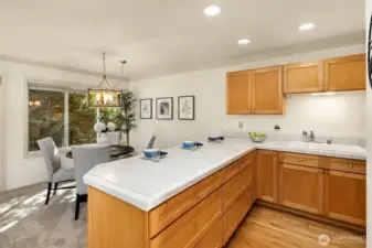 Convenient integration between the kitchen and dining room with additional breakfast bar seating
