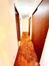 Hallway on main level leading to 4 bedrooms.