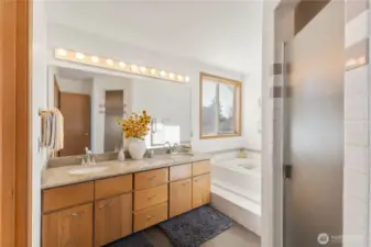 Double sinks and private water closet in bathroom suite.