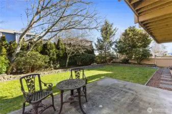 Backyard, surrounded by mature landscaping, offers privacy for apartment tenants.