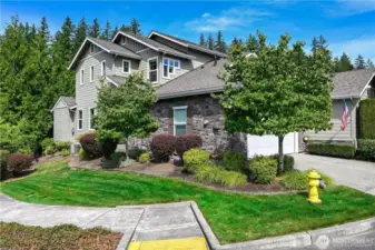 Set on a sunny, corner lot this Washington Plan offers flexible spaces for the owners.