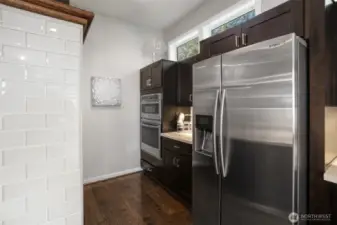 Double ovens with top oven doubling as a microwave. Note: Spacious pantry cabinets are directly across for the oven area.