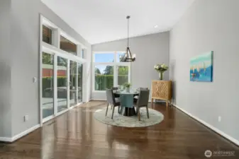 Large dining area with vaulted ceiling and sliders to covered deck, perfect for year round BBQing.