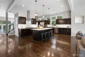 Well designed gourmet style kitchen with quartz counter tops and full height glass black splash's.