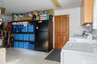 Huge utility room showing access door to garage.