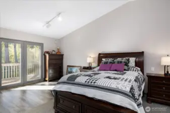 Upstairs primary bedroom has access to a nice deck overlooking the lovely back yard.