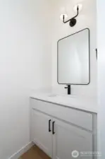 Main level guest bathroom - Pics are of a different 2389 Kyler plan home. Features and colors may differ.