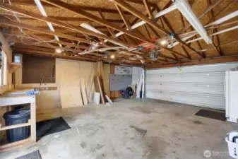 Interior garage, complete with extra refrigerator and work bench.