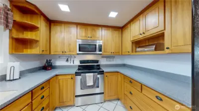 The U-shaped layout offers great workflow, a large pantry wall, and durable tile flooring for easy everyday living.