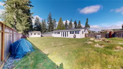 Expansive, fully fenced backyard offers plenty of room for play, gardening, pets, or future outdoor projects.