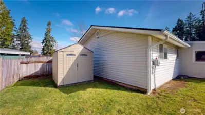 Backyard includes a convenient storage shed, offering extra space for tools, lawn equipment, and seasonal items.