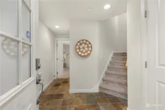 Main level entry. Up the stairs are the main living spaces. Down the hallway is your 1st bedroom, full bathroom and access to the fully fenced backyard.