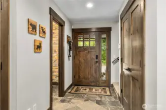 Entry way with powder bath, coat closet and upstairs access.