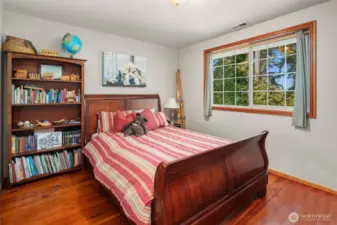 Secondary bedroom facing east. Real pine floors, generous closet. Overlooks eastern lawn.