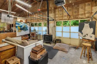 Two-car garage is enormous with high ceilings and tons of light. Currently in use as a fine artist's studio.
