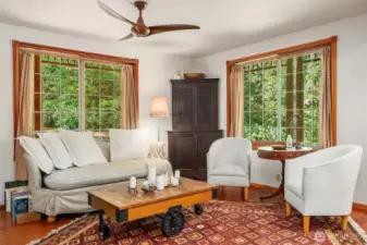 Living room enjoys light streaming in from the east and north and opens onto the kitchen/dining areas.