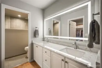 Primary bathroom has been updated with quart countertops and new walk-in shower.
