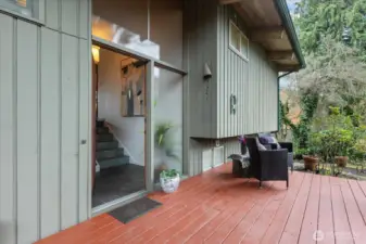 Intriguing design with level entry to the first floor from the Carport entry. A couple of steps down to this door opening to the grand entry.  Good-sized front deck looks west over the garden courtyard.