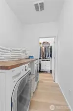 Convenient upstairs laundry with access to both the hall and the primary suite