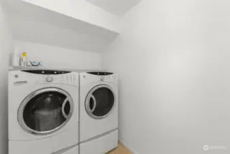 Raised washer/dryer on the upper level.