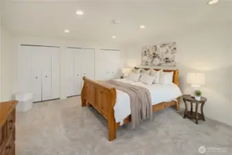 Primary bedroom with a wall of closets
