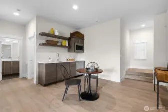 Wet bar area with microwave and mini fridge.