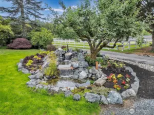 Beautiful water feature with stone and plants surrounding it!
