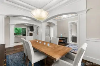 Just off the kitchen, a beautiful formal room offers the perfect setting for elegant occasions and large gatherings. A striking light fixture adds a modern flair, enhancing the home's timeless architecture.