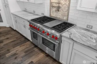 Unleash your inner chef with top-of-the-line Wolf appliances, perfect for crafting gourmet meals and delectable baked goods. A convenient pot filler above the stove adds both style and function, making cooking easier—and more enjoyable.