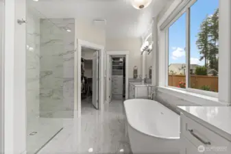Fully updated, this ultra-deluxe primary bathroom features dual vanities, 2 separate walk in closets with custom hard-surface systems, and glamorous new tile work throughout, blending luxury with thoughtful functionality.