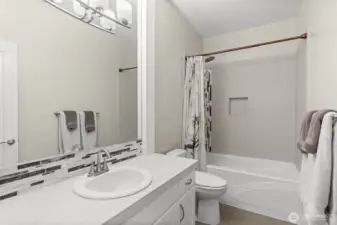 A shared full bathroom is conveniently located between 2 guest suites on the main level.