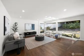 Huge living room filled with natural light from extra-large windows and additional skylights.